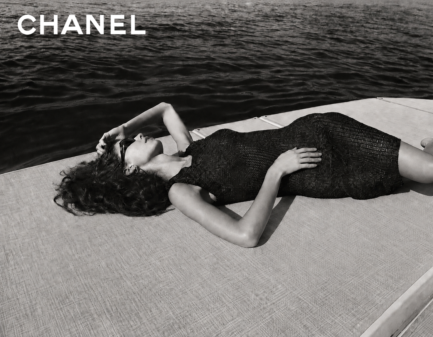 CHANEL reclining editorial beside water
